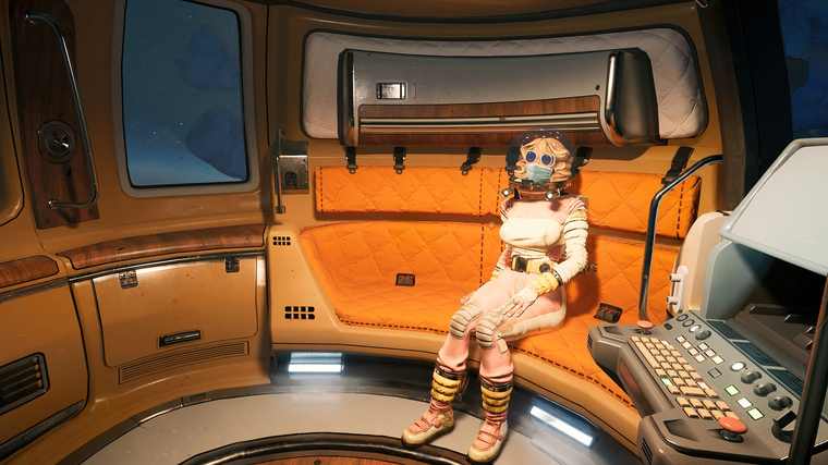 A crew member in a patched spacesuit with goggles sits on the train car's orange padded bench next to a keyboard console